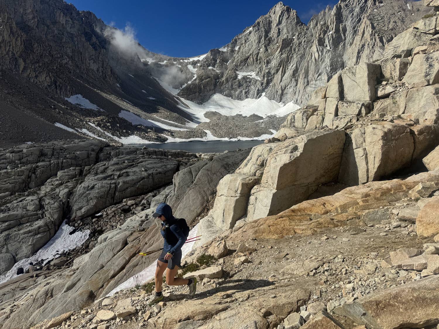 Hiker descending the Mount Whitney Trail toward the basin below