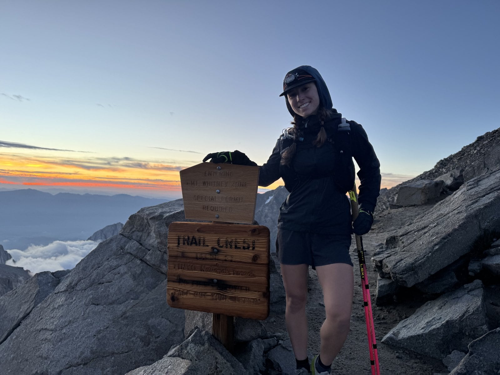 Hiker at the Trail Crest sign at 13,600 feet on the Mount Whitney Trail