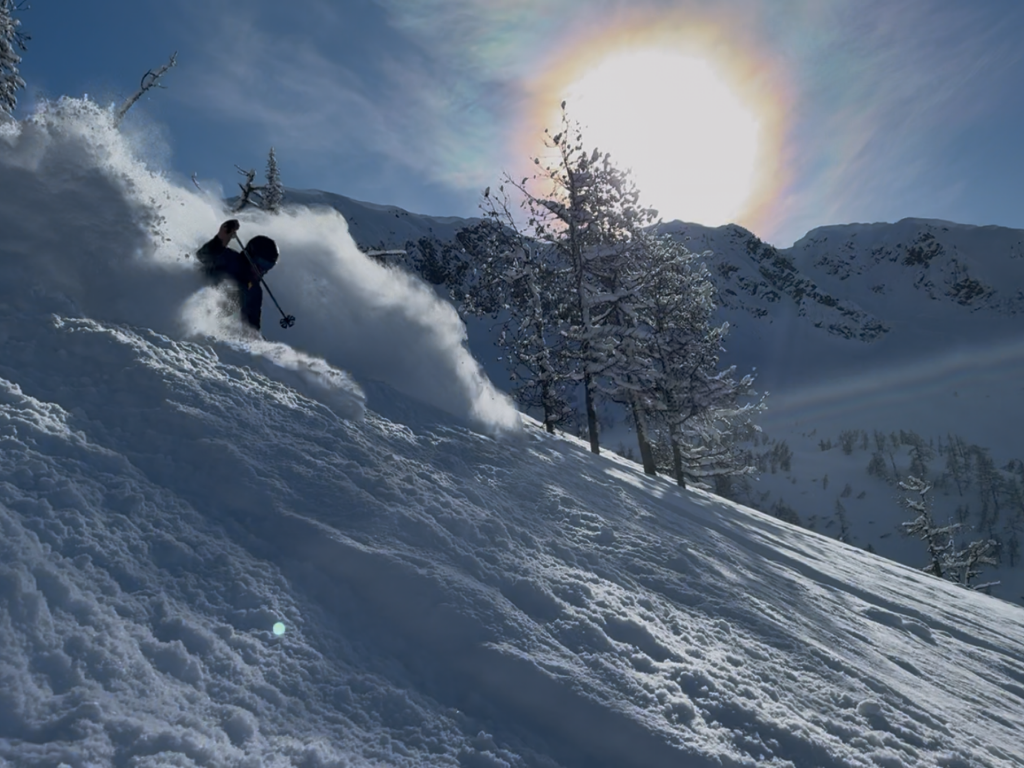 Skier linking turns through deep snow