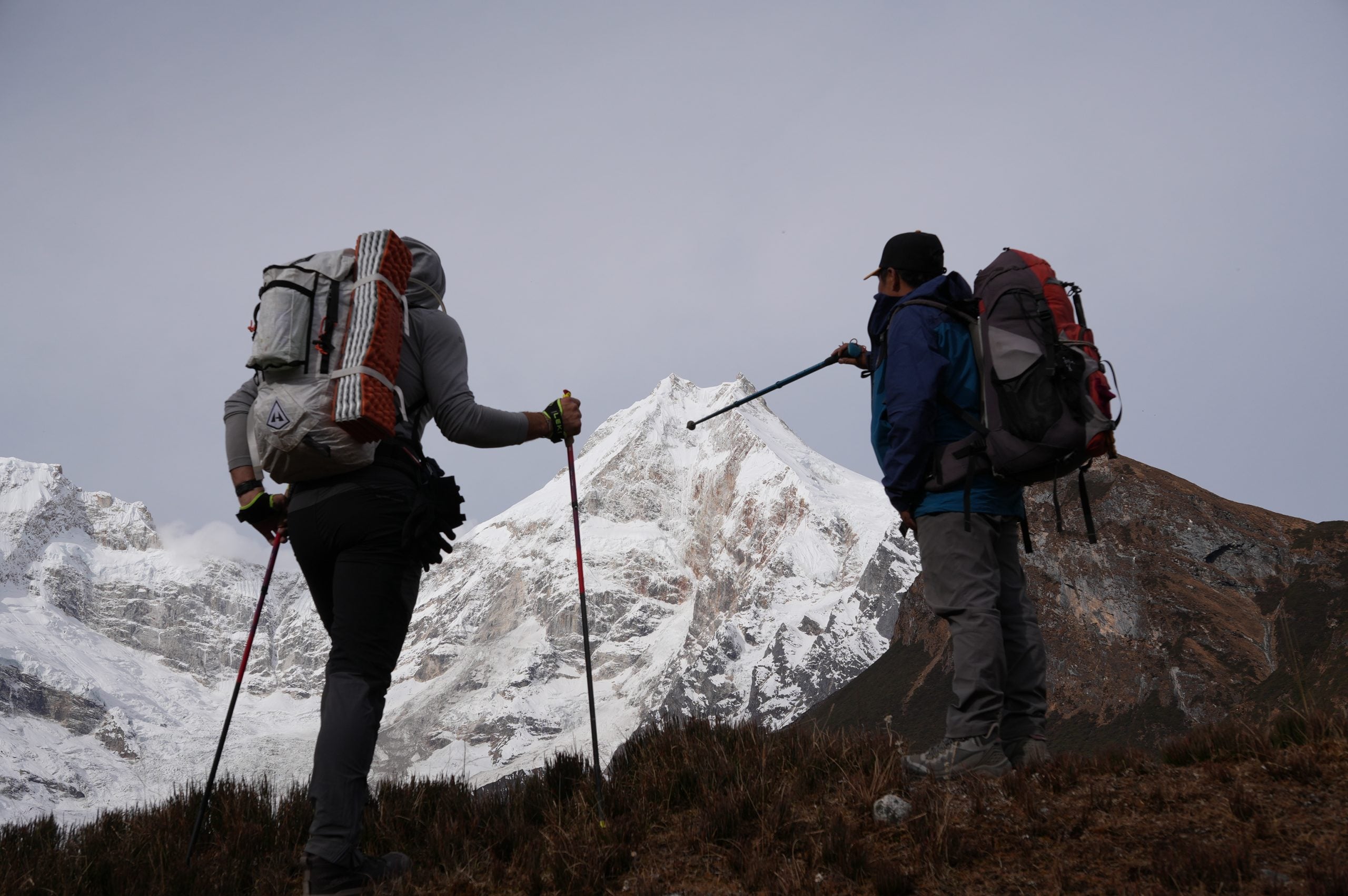 Two trekkers on the hike to Pungyen Gompa with Manaslu in the distance