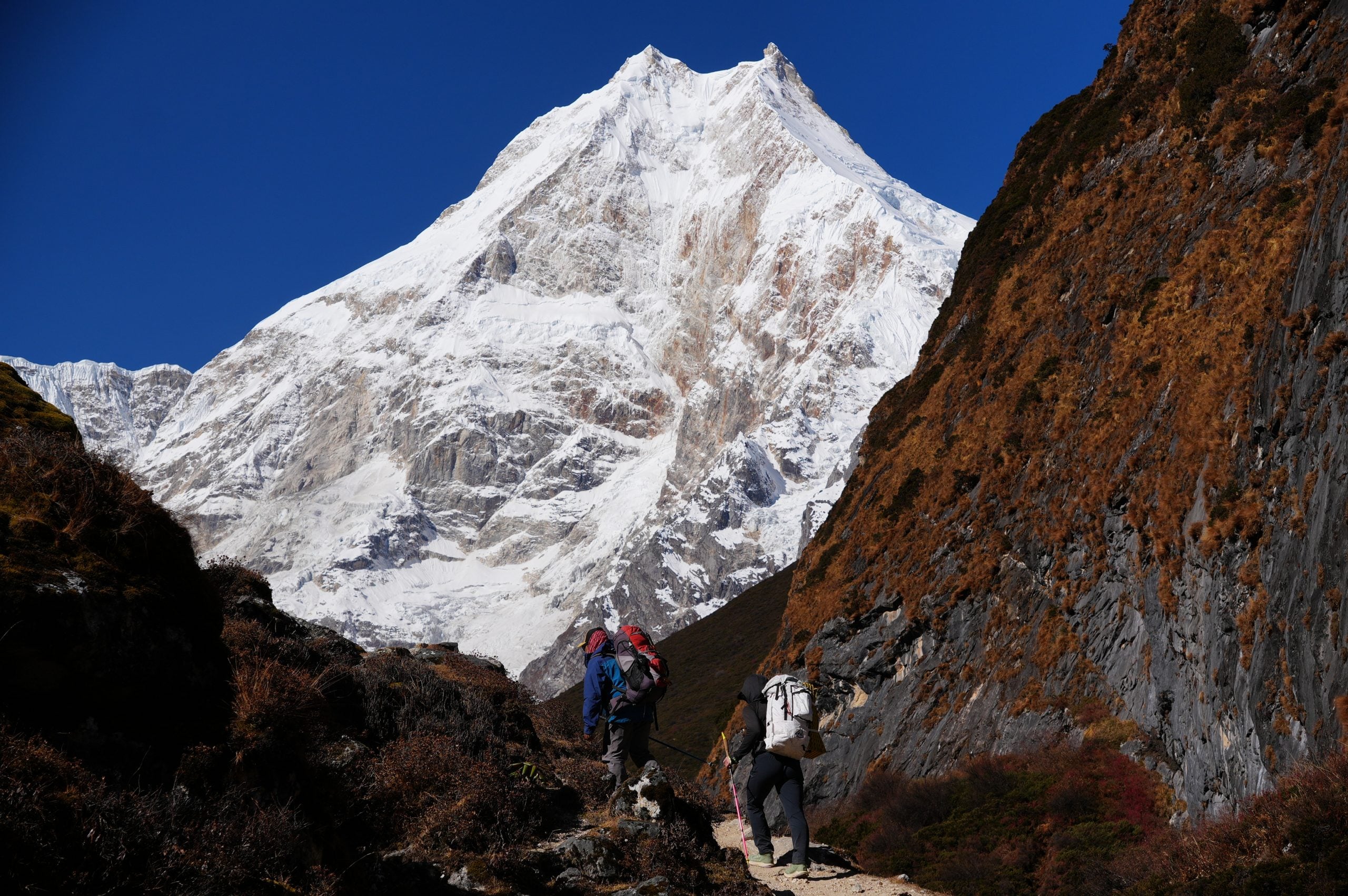 Two hikers beneath Manaslu near Pungyen Gompa